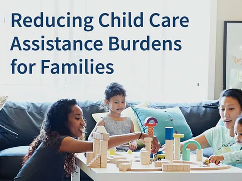 Photograph of two women and two young children playing at a table covered in wooden blocks. Text overlaid on the image reads 'Reducing child care assistance burdens for families.'